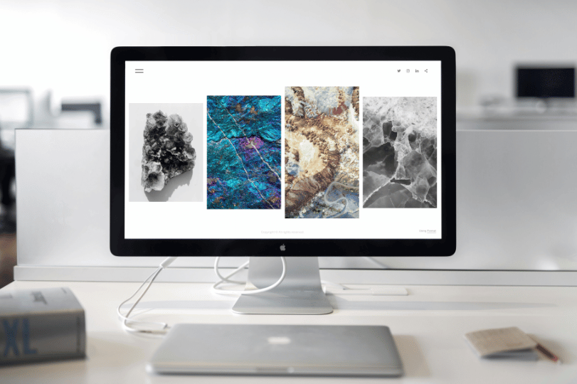 Desktop monitor displaying portfolio website with image gallery - Professional website development and custom web design services - responsive WordPress websites by Develoroo