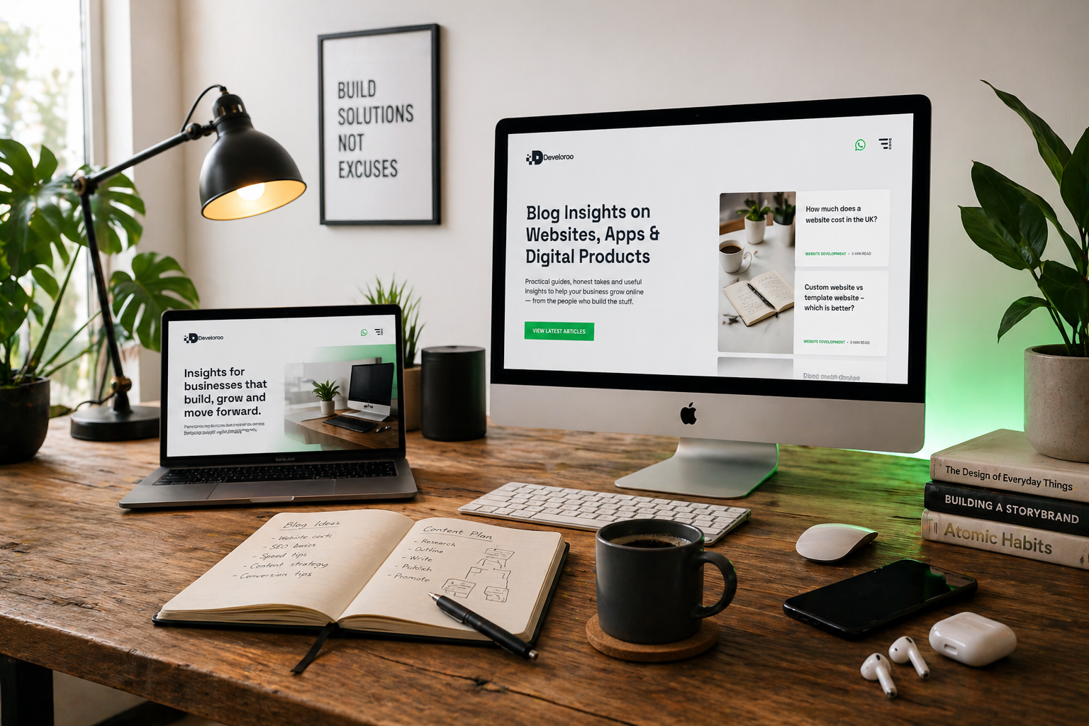Modern founder-led web design workspace with iMac and MacBook displaying premium business website layouts, blog content strategy notes, warm desk lamp, coffee cup and creative digital agency office setup for Develoroo web design services.